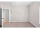 Simple bedroom with neutral walls, carpet flooring, and a window offering sunlight at 17618 Cortes Creek Blvd, Spring Hill, FL 34610