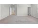 Bedroom with neutral carpet, paint, and views to bathroom and hallway at 17618 Cortes Creek Blvd, Spring Hill, FL 34610