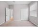 Neutral bedroom with a view of the hallway through an opened white door at 17618 Cortes Creek Blvd, Spring Hill, FL 34610