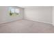 An ample bedroom with neutral walls, carpet, and a window at 17618 Cortes Creek Blvd, Spring Hill, FL 34610