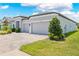 Charming home with a two car garage, a paver driveway, a well manicured lawn and lush landscaping at 17618 Cortes Creek Blvd, Spring Hill, FL 34610