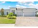 Charming single-story home featuring a three-car garage and beautiful front yard landscaping at 17618 Cortes Creek Blvd, Spring Hill, FL 34610