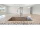 Close up of a large kitchen island with granite counters and a stainless steel sink and faucet at 17618 Cortes Creek Blvd, Spring Hill, FL 34610