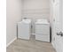 Functional laundry room with side-by-side washer and dryer units at 17618 Cortes Creek Blvd, Spring Hill, FL 34610