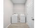 Bright laundry room with white appliances and ample shelving space at 17618 Cortes Creek Blvd, Spring Hill, FL 34610