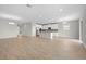 Spacious open floor plan living room and kitchen with stainless appliances, white cabinets and tile floors at 17618 Cortes Creek Blvd, Spring Hill, FL 34610