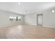 Bright, open living area with tile floors, recessed lighting, and large windows that fill the space with natural light at 17618 Cortes Creek Blvd, Spring Hill, FL 34610