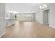 Expansive living area with wood-look tile, slider access to the outside, and natural light, great for relaxation at 17618 Cortes Creek Blvd, Spring Hill, FL 34610