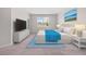 An inviting primary bedroom displays a TV, dresser, bed, and serene wall art at 17618 Cortes Creek Blvd, Spring Hill, FL 34610