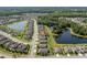 Scenic aerial shot of a neighborhood with homes nestled around beautiful lakes and lush greenery at 18428 Malinche Loop, Spring Hill, FL 34610