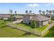 Well-maintained backyard with lush green grass, a white fence, and a cozy covered patio at 18428 Malinche Loop, Spring Hill, FL 34610