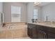 Bathroom with a soaking tub, granite countertop, and double vanity at 18428 Malinche Loop, Spring Hill, FL 34610
