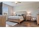 Comfortable bedroom featuring a wooden bed frame, ceiling fan, and bright natural light at 18428 Malinche Loop, Spring Hill, FL 34610