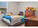 Fun bedroom features a themed bed, dresser with toys, and a window for natural light at 18428 Malinche Loop, Spring Hill, FL 34610