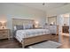 Bedroom featuring a wooden bed frame, wood-look floors, and neutral tones at 18428 Malinche Loop, Spring Hill, FL 34610