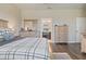 Bedroom showcasing a walk-in closet, wood-look floors, and neutral tones at 18428 Malinche Loop, Spring Hill, FL 34610
