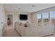 Living area featuring a comfortable sofa and a mounted flat-screen TV at 18428 Malinche Loop, Spring Hill, FL 34610