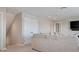 Bonus room featuring a plush sofa, double doors, and carpet flooring at 18428 Malinche Loop, Spring Hill, FL 34610