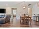 Open-concept dining area with hard wood floors, neutral tones, and inviting ambiance at 18428 Malinche Loop, Spring Hill, FL 34610