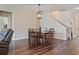 Charming dining area featuring wood table, wood flooring, and an open-concept layout at 18428 Malinche Loop, Spring Hill, FL 34610