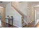 Inviting foyer with wood floors, stairs, and a decorative table with plants at 18428 Malinche Loop, Spring Hill, FL 34610