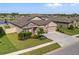 Aerial view of home showcasing landscaping, water view, and a two-car garage at 18428 Malinche Loop, Spring Hill, FL 34610