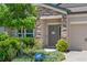 Charming entrance with stone accents, lush landscaping, and a welcoming front door at 18428 Malinche Loop, Spring Hill, FL 34610