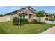 Well-maintained home featuring a manicured lawn and landscaping, showcasing its curb appeal at 18428 Malinche Loop, Spring Hill, FL 34610