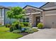 Charming single-Gathering home with stone accents, landscaping, and a well-maintained lawn at 18428 Malinche Loop, Spring Hill, FL 34610