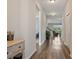 Hallway with hardwood floors leading to the bright living area, showcasing the home's layout at 18428 Malinche Loop, Spring Hill, FL 34610