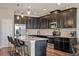 Modern kitchen featuring dark cabinets, stainless steel appliances, and a stylish mosaic backsplash at 18428 Malinche Loop, Spring Hill, FL 34610