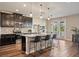 Bright kitchen with stainless appliances, granite countertops, a long island and bar stool seating at 18428 Malinche Loop, Spring Hill, FL 34610