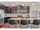 Beautiful kitchen with stainless steel appliances, granite countertops and dark cabinetry at 18428 Malinche Loop, Spring Hill, FL 34610