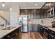 Spacious kitchen with stainless steel appliances, granite countertops, and wood flooring at 18428 Malinche Loop, Spring Hill, FL 34610