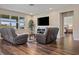 Inviting living room showcasing hard wood floors, neutral color palette and abundant natural light at 18428 Malinche Loop, Spring Hill, FL 34610