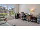 Comfortable carpeted office with window views and modern desk at 18428 Malinche Loop, Spring Hill, FL 34610