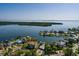 Aerial view of coastal home showcases lush landscaping, a private pool, and waterfront access at 1857 Bayou Grande Ne Blvd, St Petersburg, FL 33703
