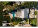 Aerial view of a waterfront home with a pool, boat dock, lush landscaping, and a metal roof at 1857 Bayou Grande Ne Blvd, St Petersburg, FL 33703