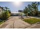 Charming home boasts a well-maintained front yard with mature trees and a circular driveway at 1857 Bayou Grande Ne Blvd, St Petersburg, FL 33703