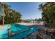 Tranquil pool area with lounge chairs, lush tropical landscaping, and easy access to the waterfront dock at 1857 Bayou Grande Ne Blvd, St Petersburg, FL 33703