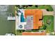 Aerial view of a waterfront property with a pool, dock, and lush landscaping at 1901 Kansas Ne Ave, St Petersburg, FL 33703