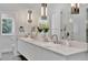 Well-lit bathroom with a double vanity, quartz countertop, and modern fixtures and ample mirror space at 1901 Kansas Ne Ave, St Petersburg, FL 33703