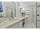 Bathroom featuring a double sink vanity, modern fixtures, and glass-enclosed shower at 1901 Kansas Ne Ave, St Petersburg, FL 33703