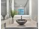 Close-up of a modern bathroom sink and countertop with stylish decor and lighted mirror at 1901 Kansas Ne Ave, St Petersburg, FL 33703