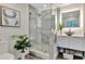 Bathroom with a glass-enclosed shower, modern sink, and vanity with decorative items at 1901 Kansas Ne Ave, St Petersburg, FL 33703
