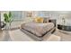 Cozy bedroom featuring a platform bed with decorative pillows and shutters for natural light at 1901 Kansas Ne Ave, St Petersburg, FL 33703