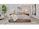 Beautifully staged bedroom features a large bed with decorative pillows and modern decor at 1901 Kansas Ne Ave, St Petersburg, FL 33703