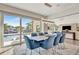 Open dining room boasts modern chandelier and waterfront views from sliding glass doors at 1901 Kansas Ne Ave, St Petersburg, FL 33703