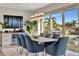 Bright dining room with modern lighting fixture and serene water views through the large window at 1901 Kansas Ne Ave, St Petersburg, FL 33703