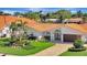 Stunning single-story home with a red tile roof, beautiful landscaping, and a brick driveway at 1901 Kansas Ne Ave, St Petersburg, FL 33703